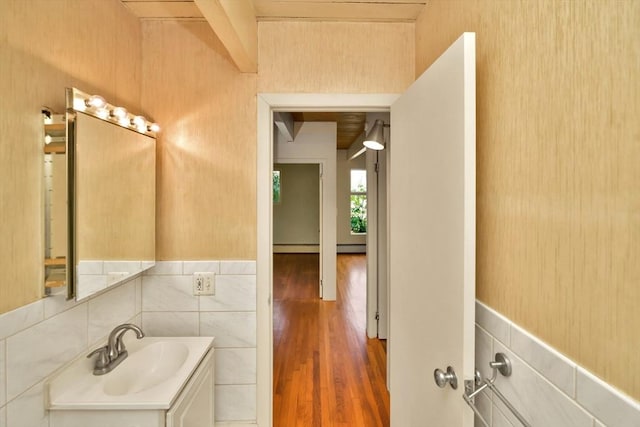 bathroom featuring beamed ceiling, vanity, and wood finished floors