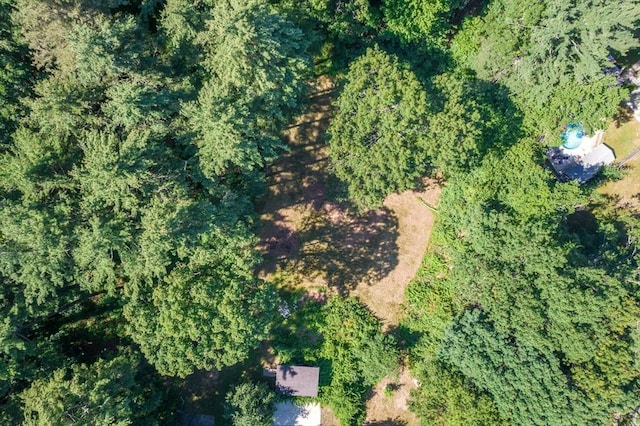 birds eye view of property with a view of trees