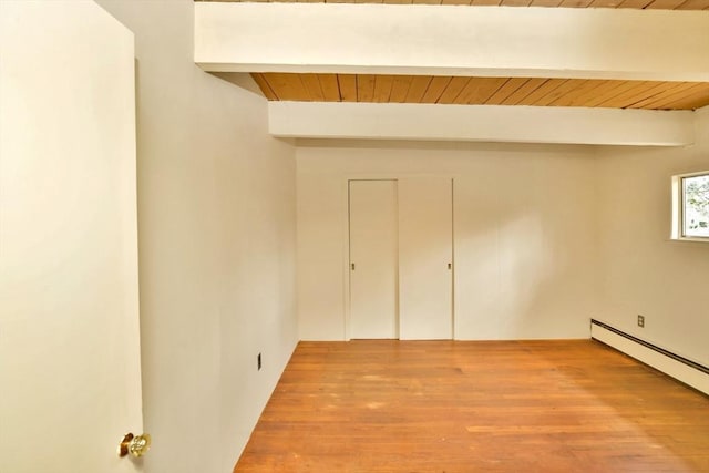 unfurnished bedroom with beamed ceiling, a baseboard radiator, wooden ceiling, and wood finished floors