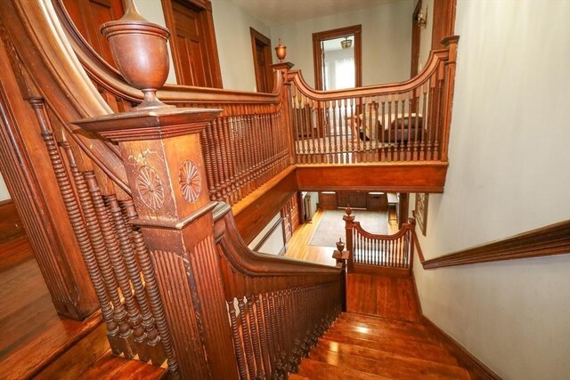 staircase with wood-type flooring