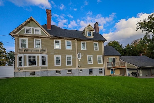 back of property with a lawn and a chimney