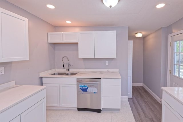 kitchen featuring dishwasher, a sink, white cabinetry, light stone countertops, and recessed lighting