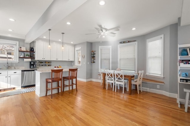 kitchen with stainless steel dishwasher, open shelves, white cabinets, and light wood finished floors