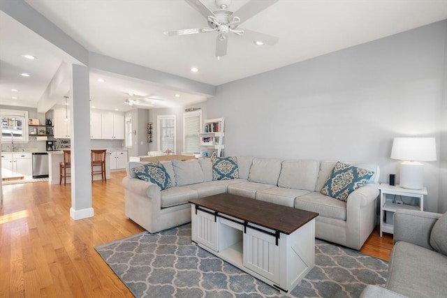 living room with recessed lighting, light wood-type flooring, and a ceiling fan