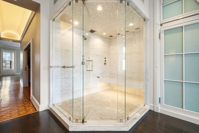 bathroom with hardwood / wood-style floors and walk in shower