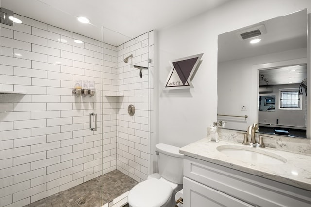 bathroom featuring an enclosed shower, toilet, and vanity