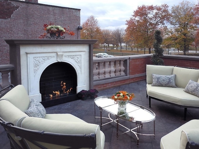 view of patio with an outdoor living space with a fireplace