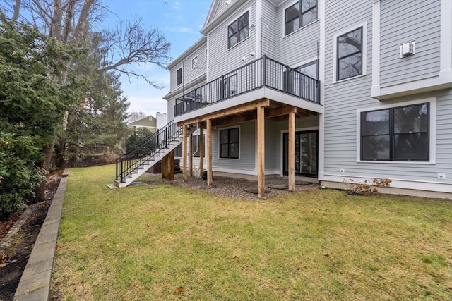 39 Donna Rd, Needham, MA 02494 - back of property with stairway, a wooden deck, and a yard