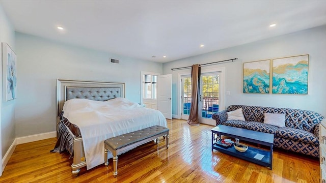 bedroom with access to exterior, light wood-style flooring, baseboards, and recessed lighting