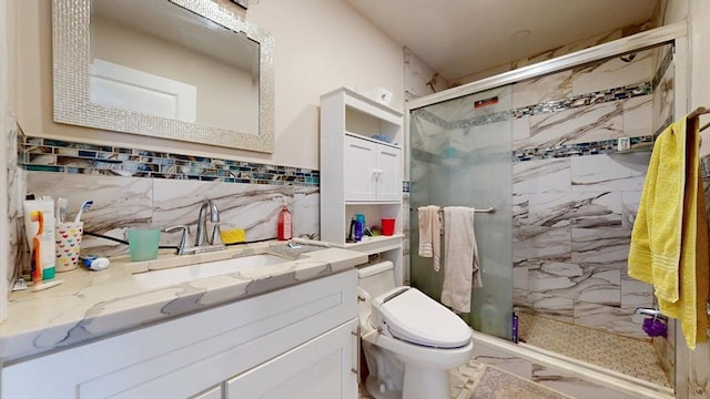 full bath featuring a stall shower, toilet, vanity, and backsplash
