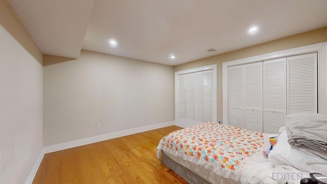 bedroom featuring baseboards, recessed lighting, light wood-style flooring, and a closet