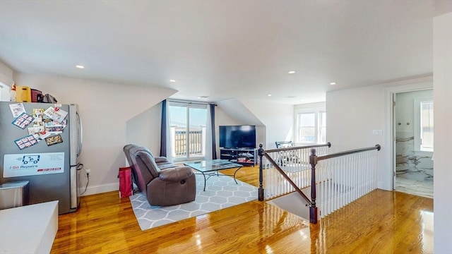 living room featuring wood finished floors, recessed lighting, and baseboards