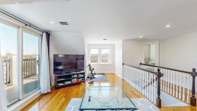 workout room with wood finished floors, baseboards, and recessed lighting