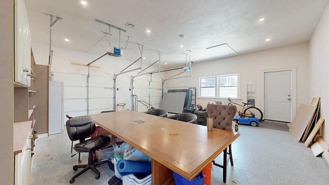 home office featuring recessed lighting and a garage