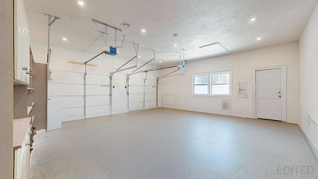 garage with a garage door opener and recessed lighting