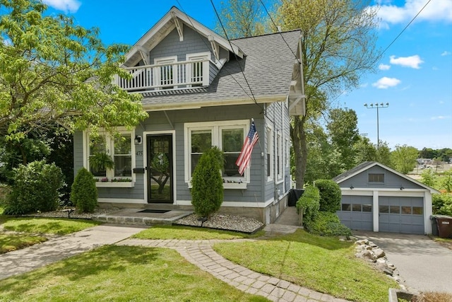 475 E St, Dedham, MA 02026 - view of front facade with a balcony, roof with shingles, an outbuilding, and a front yard
