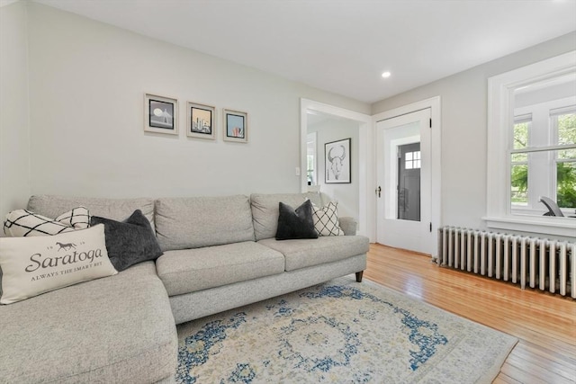 475 E St, Dedham, MA 02026 - living room featuring radiator heating unit, wood finished floors, and recessed lighting