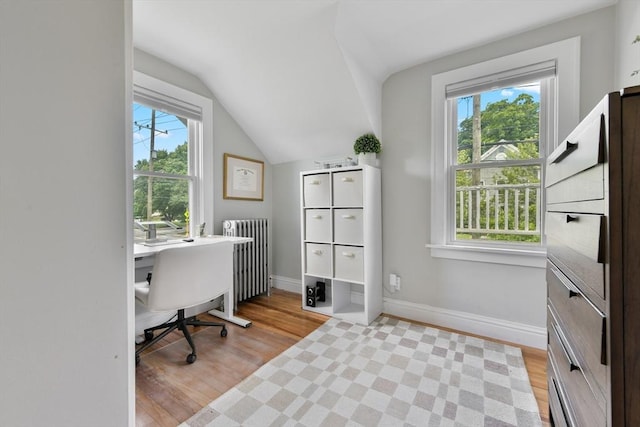 475 E St, Dedham, MA 02026 - home office with light wood-type flooring, lofted ceiling, baseboards, and radiator heating unit