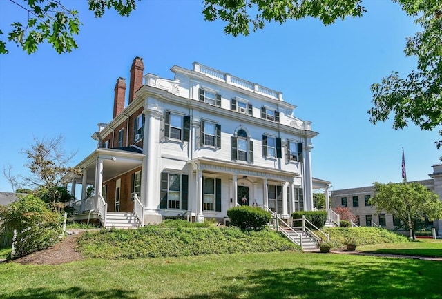 475 E St, Dedham, MA 02026 - view of front of property featuring a porch, a front lawn, and a chimney
