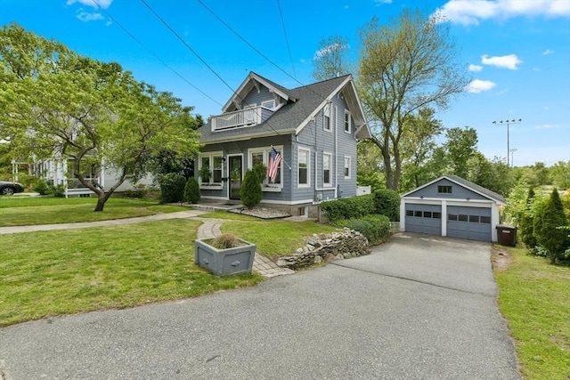 475 E St, Dedham, MA 02026 - view of front facade with a balcony, a detached garage, an outdoor structure, and a front lawn