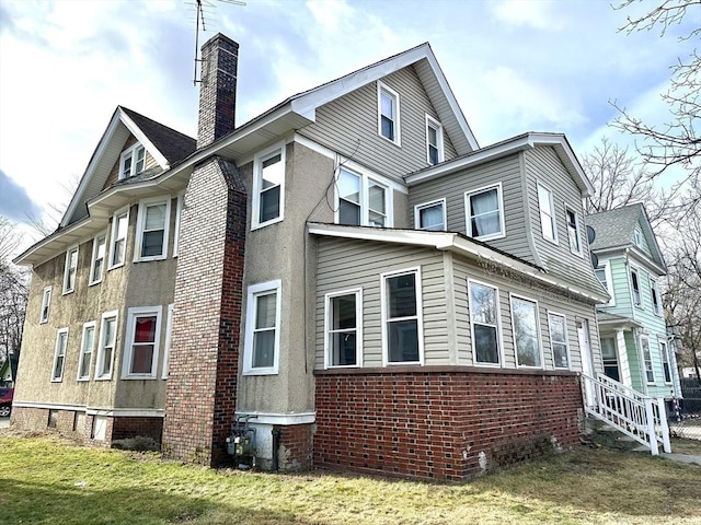 view of property exterior with a yard