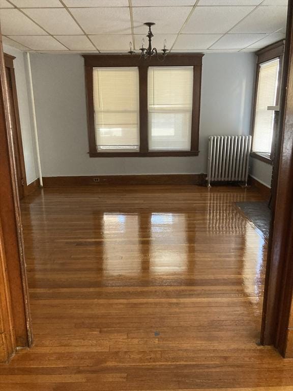 unfurnished room with radiator and dark hardwood / wood-style flooring