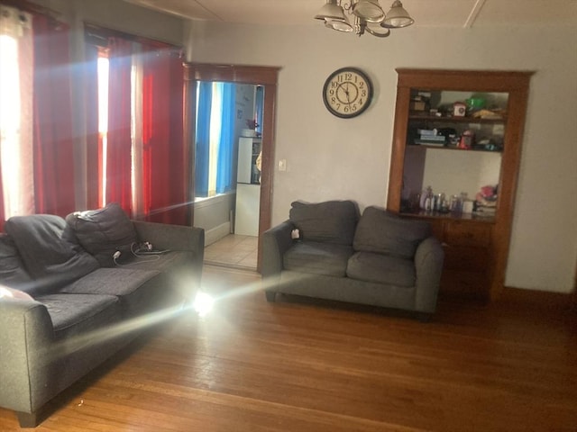 living room with hardwood / wood-style floors and a chandelier