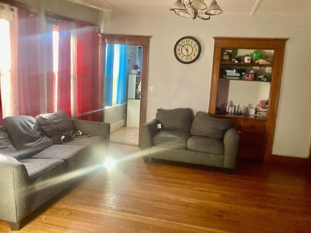 living room featuring hardwood / wood-style floors and a notable chandelier