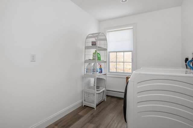 interior space with washer and dryer, a baseboard radiator, baseboards, and wood finished floors