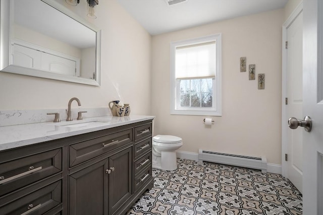 bathroom featuring baseboards, toilet, baseboard heating, tile patterned floors, and vanity