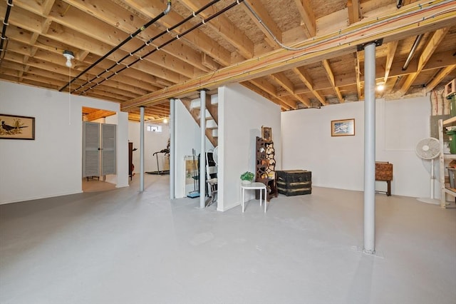 unfinished basement featuring stairs