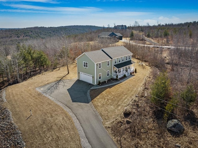 aerial view featuring a wooded view