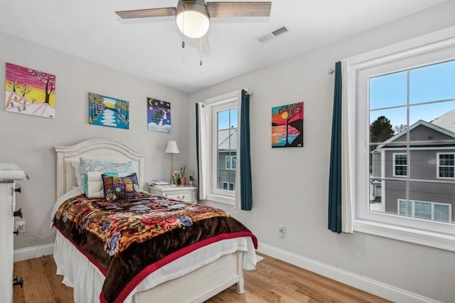 bedroom with light hardwood / wood-style floors and ceiling fan