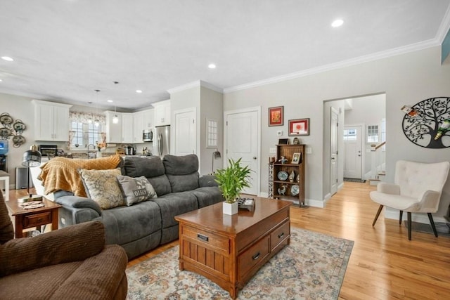 living room featuring ornamental molding and light hardwood / wood-style floors