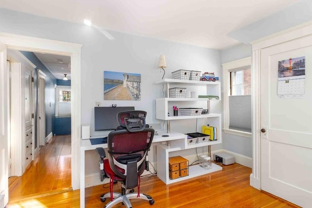 office area featuring baseboards and wood finished floors