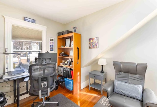 home office with baseboards and wood finished floors