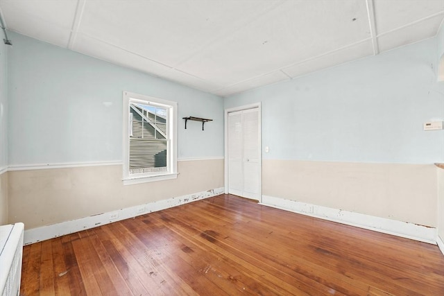 empty room with hardwood / wood-style flooring