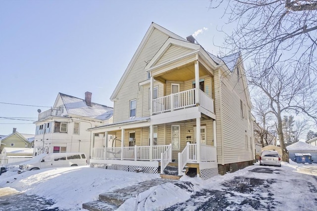 view of front facade featuring a balcony and covered porch