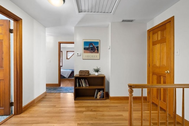 hallway with light hardwood / wood-style floors