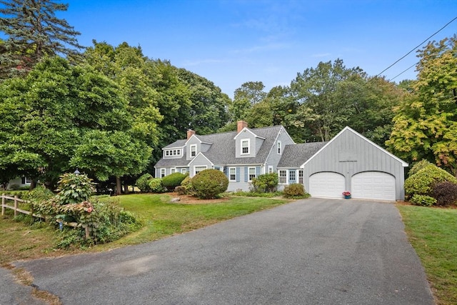 view of front of house with a garage and a front lawn