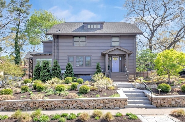 american foursquare style home with a shingled roof
