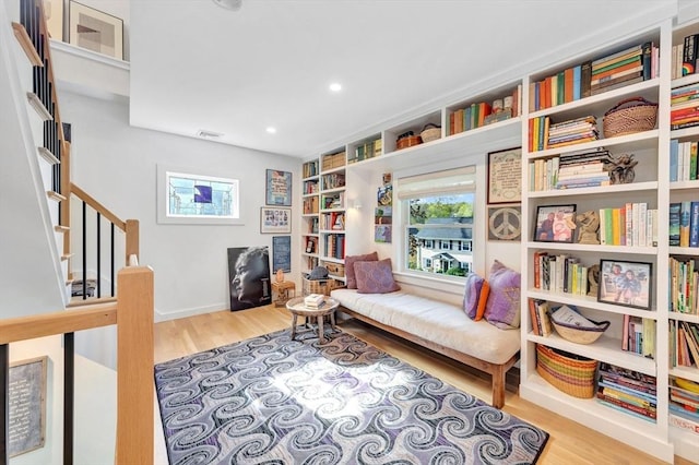 sitting room featuring baseboards, recessed lighting, and wood finished floors