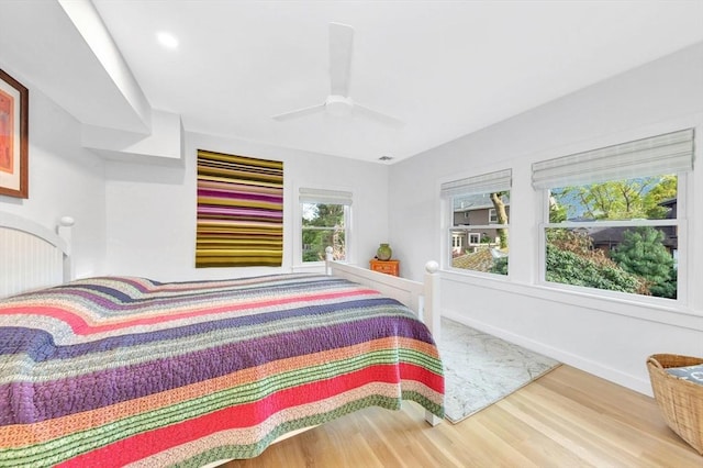 bedroom with baseboards, a ceiling fan, and wood finished floors