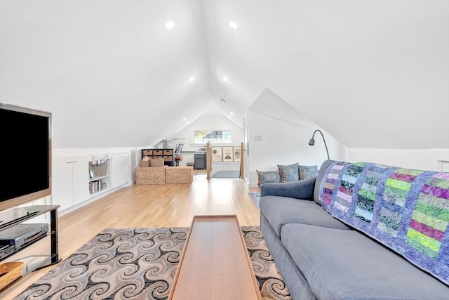 living room featuring wood finished floors and lofted ceiling