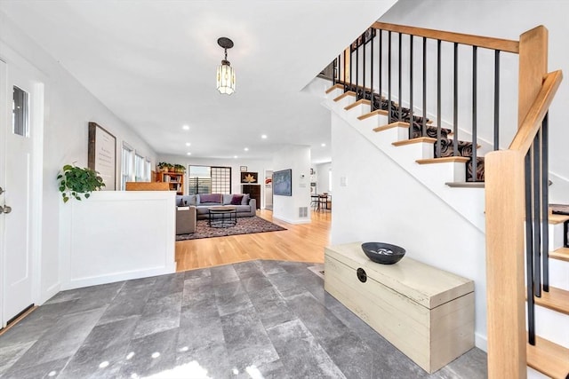 entryway featuring stairs, recessed lighting, baseboards, and wood finished floors