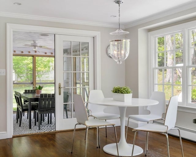 dining area featuring plenty of natural light, wood finished floors, crown molding, and ceiling fan