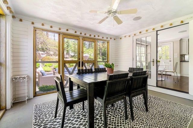 dining area with a ceiling fan, french doors, and ornamental molding