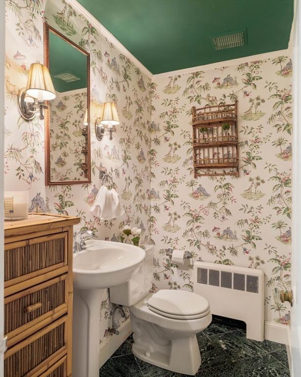 bathroom featuring radiator, baseboards, toilet, and wallpapered walls