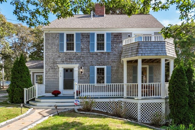 315 Pleasant St, Chatham, MA 02659 - view of front facade with a chimney, a balcony, roof with shingles, and covered porch