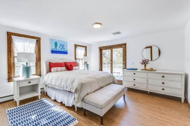 315 Pleasant St, Chatham, MA 02659 - bedroom featuring access to outside, wood finished floors, and baseboard heating